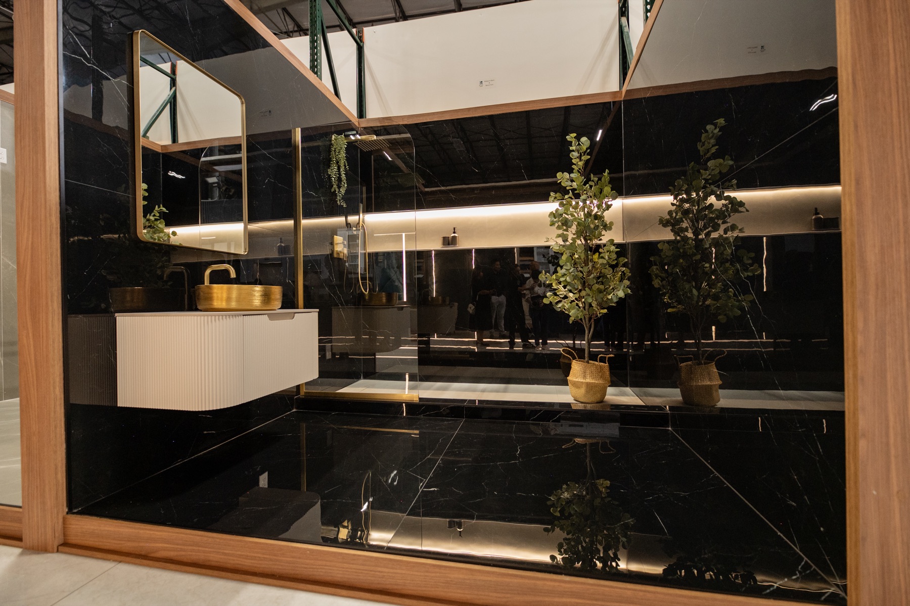 Black marble-look bathroom display with gold fixtures